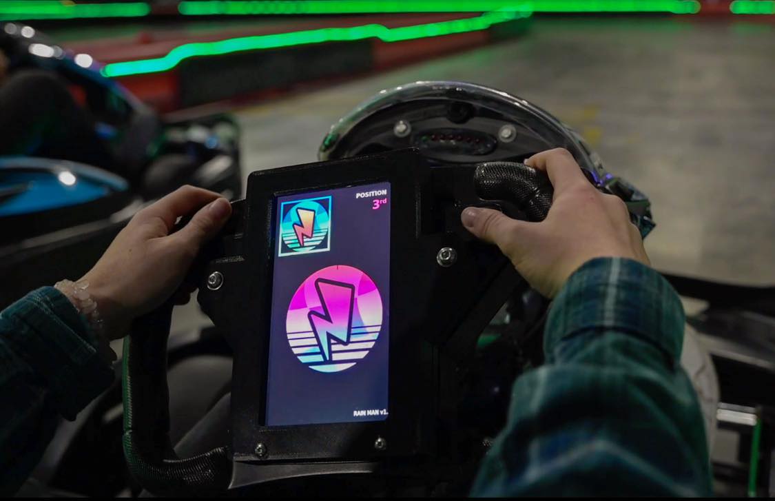 Kart steering wheel with a digital boost power-up display showing a lightning bolt icon and race position